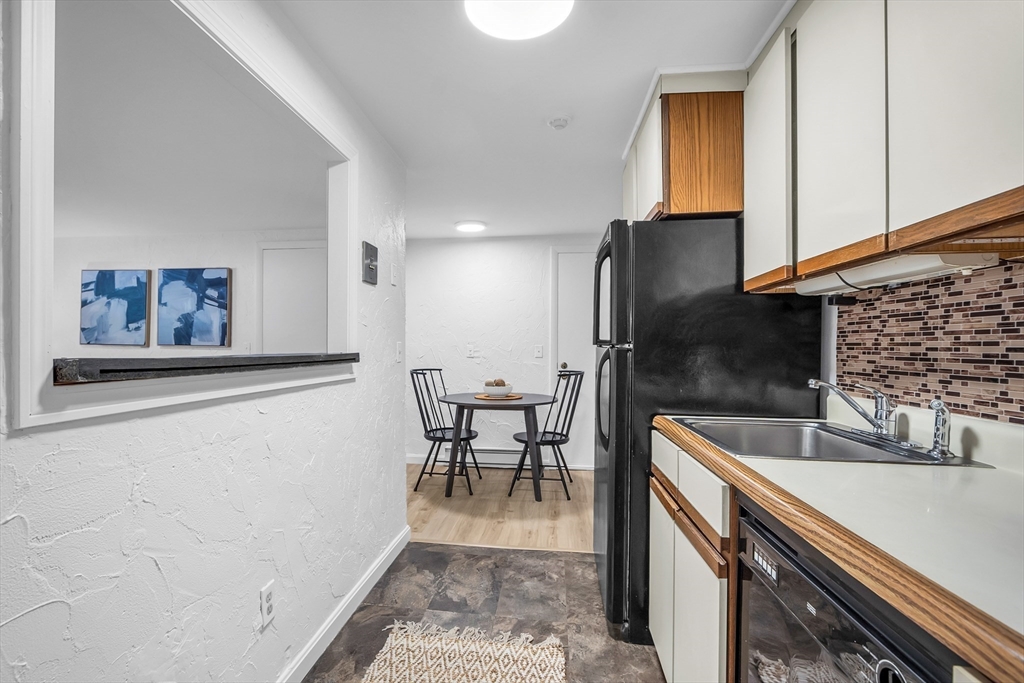208 Swanson Road, Unit 526 Boxborough, MA 01719 - Photo 10 of 23 a kitchen with stainless steel appliances granite countertop a sink and a refrigerator