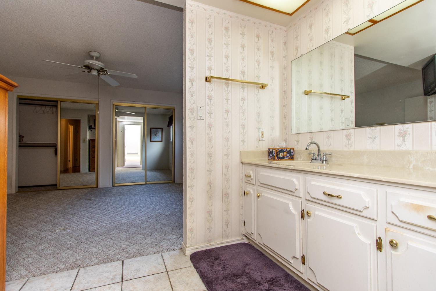 1540 Switzer Court Modesto, CA 95350 - Photo 20 of 43 a bathroom with a sink a mirror and a shower