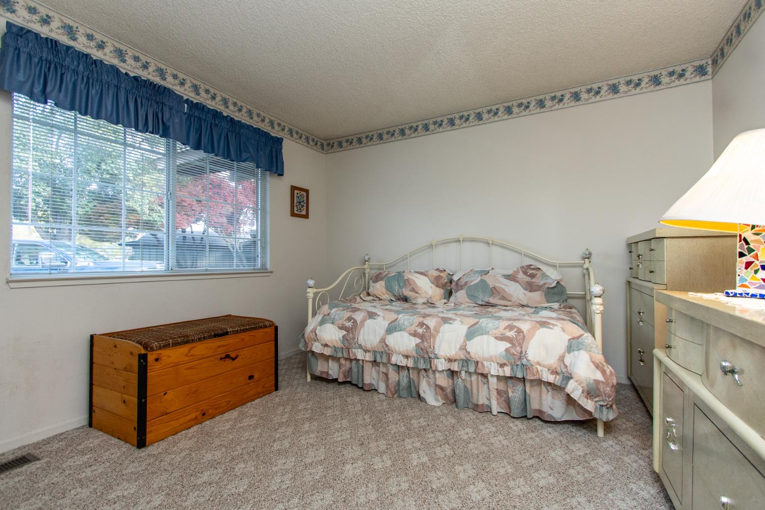 1540 Switzer Court Modesto, CA 95350 - Photo 24 of 43 a bedroom with a bed and a painting on the wall