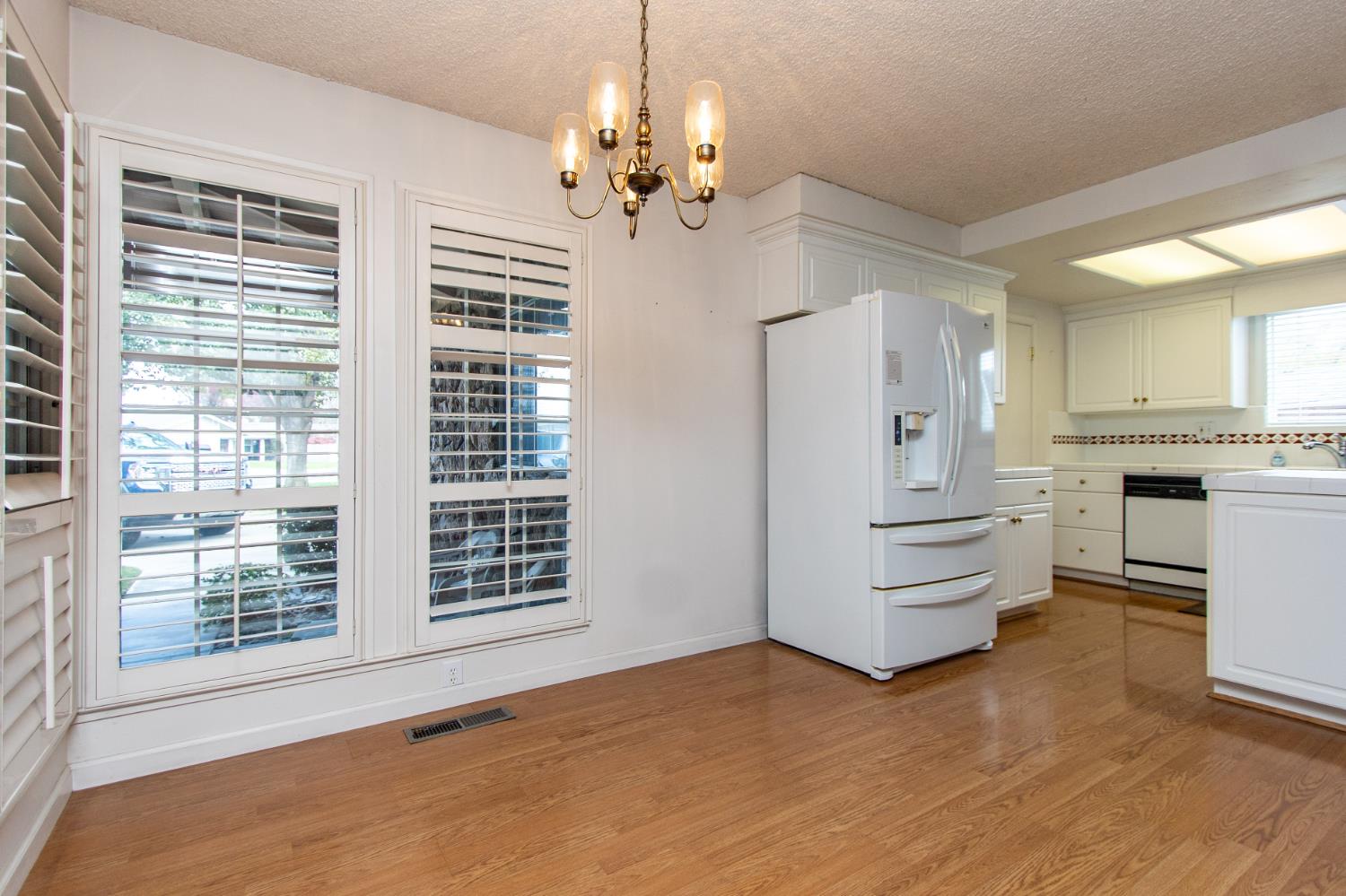 1540 Switzer Court Modesto, CA 95350 - Photo 5 of 43 a view of an empty room with a kitchen and a window