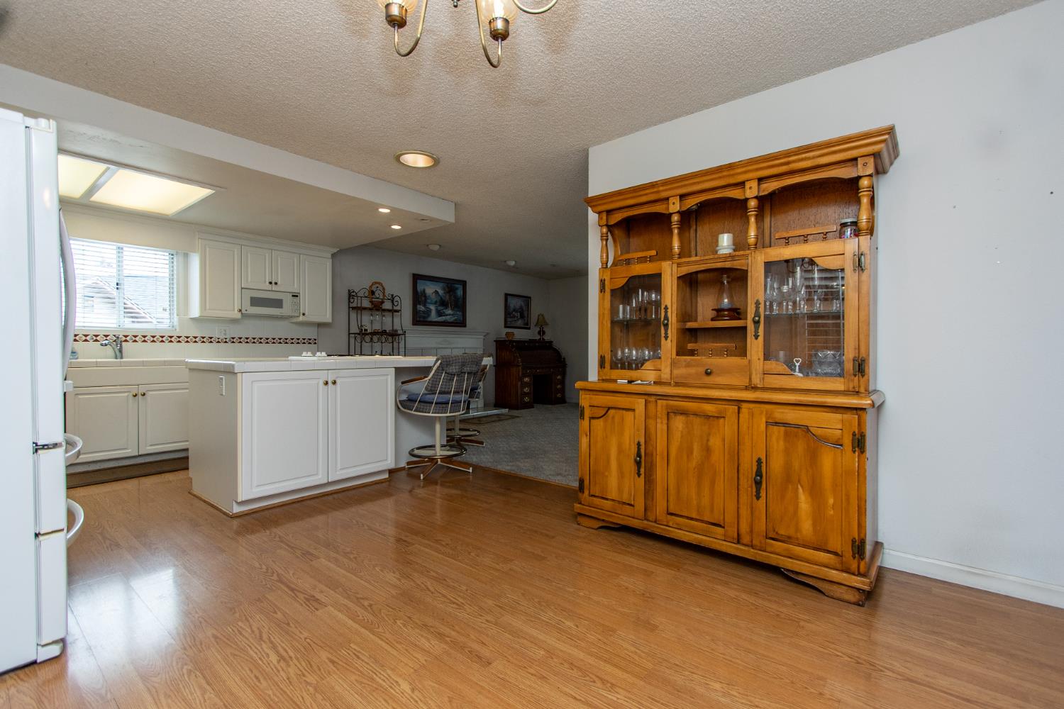1540 Switzer Court Modesto, CA 95350 - Photo 6 of 43 a view of a kitchen with a sink cabinets and wooden floor