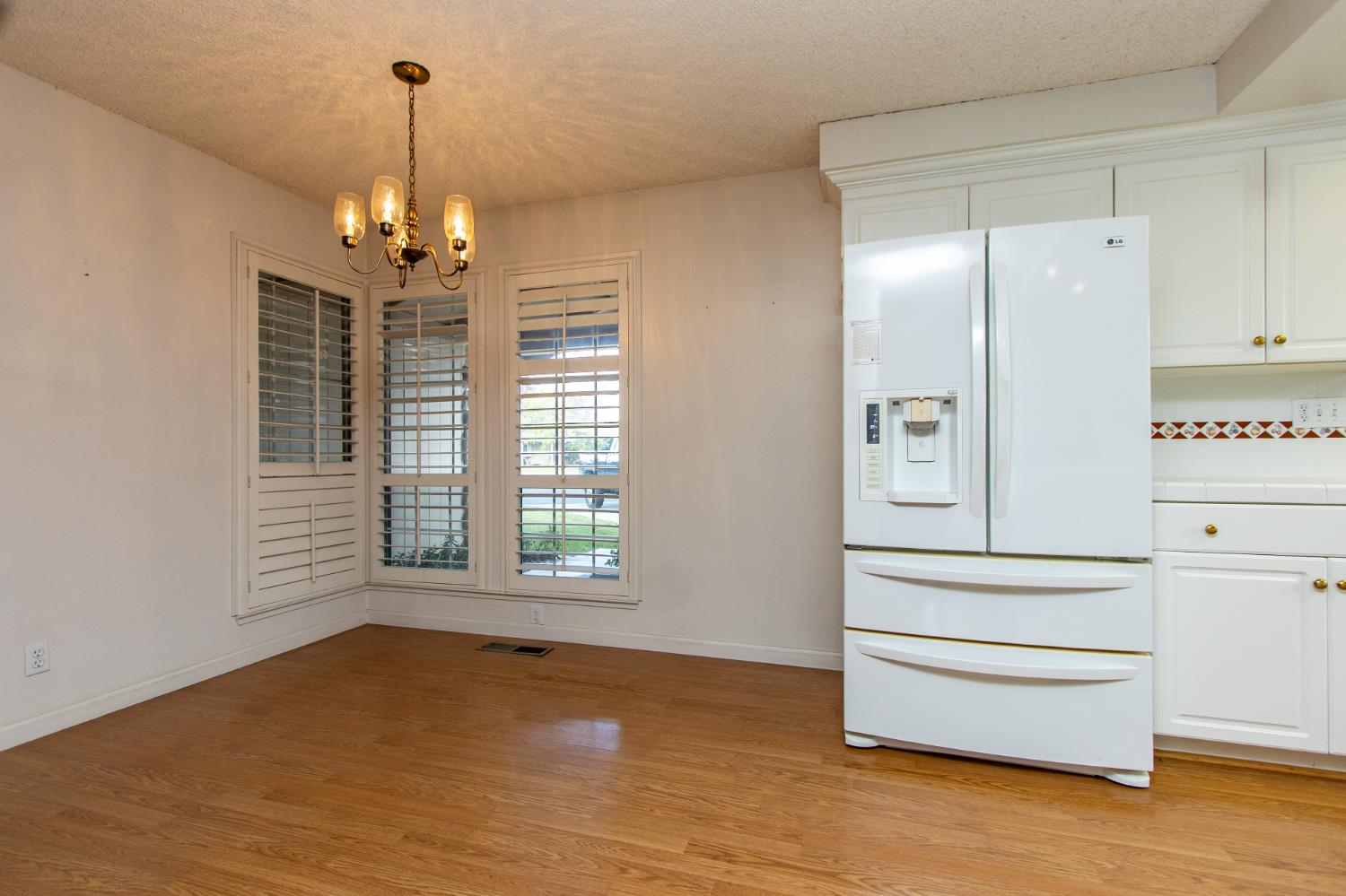 1540 Switzer Court Modesto, CA 95350 - Photo 7 of 43 a view of empty room with wooden floor and fan