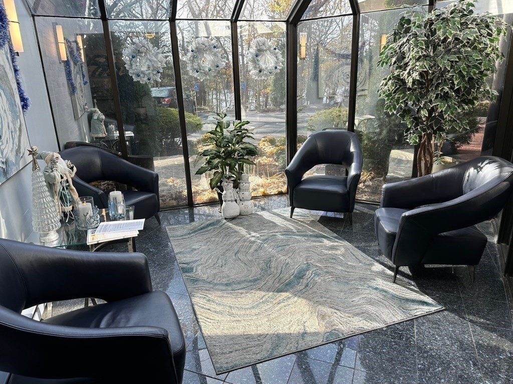 9 Broadway, Unit 223 Saugus, MA 01906 - Photo 17 of 23 a living room with furniture and a floor to ceiling window