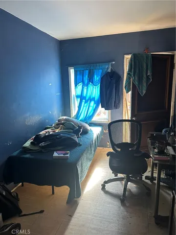 a bed room with a bed and a chair