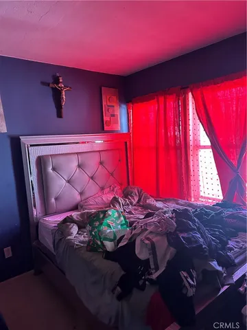 a bed room with a bed and a chair