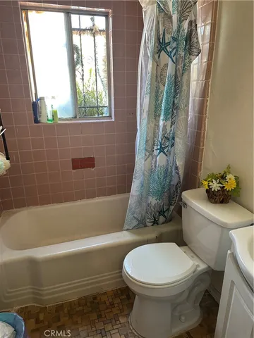 a bathroom with a toilet and a bathtub