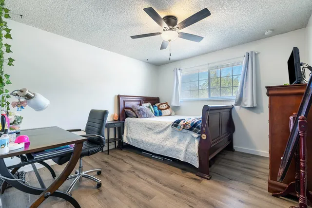 a bedroom with a bed a table and chair