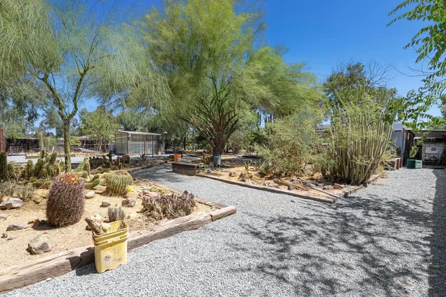 a view of a patio with a table and chairs and potted plants