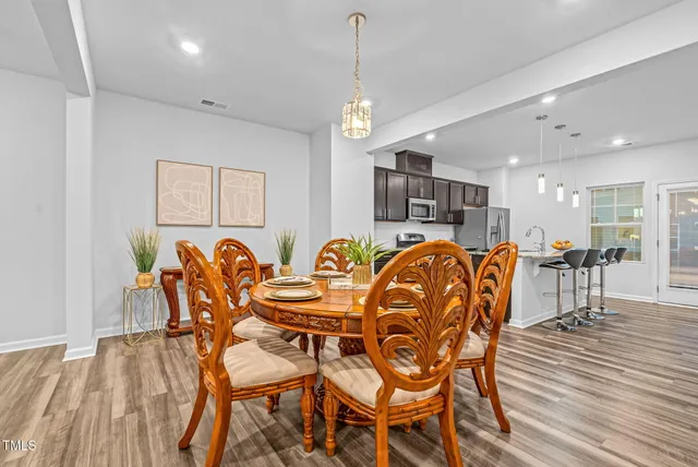 a kitchen with stainless steel appliances a stove a sink a microwave a refrigerator and cabinets