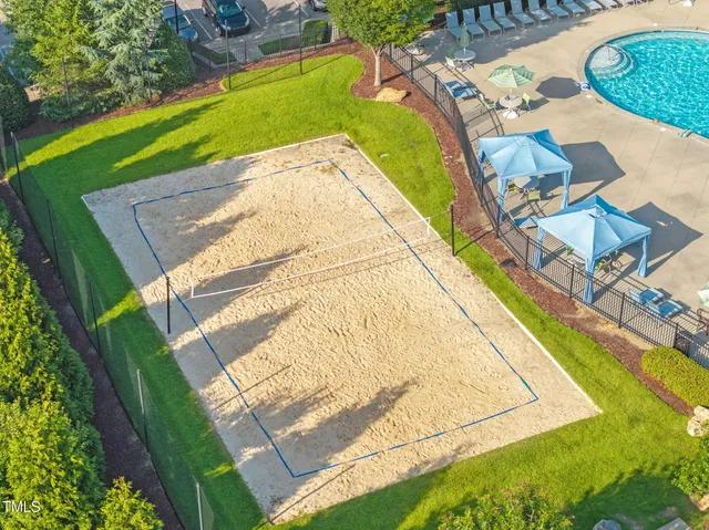 an aerial view of a house with swimming pool and outdoor seating
