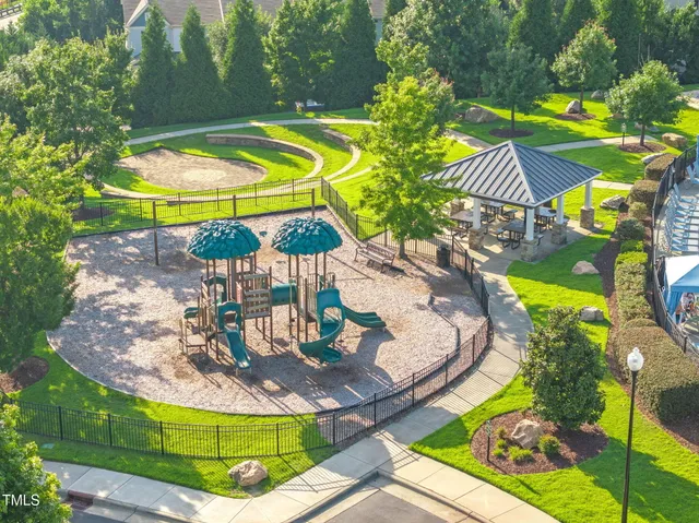 an aerial view of a swimming pool a yard and outdoor seating
