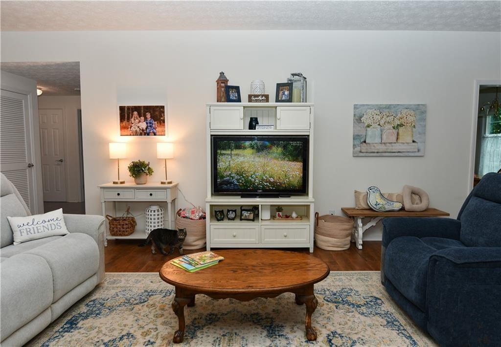 795 Sunset Ridge Lane Southeast Lawrenceville, GA 30045 - Photo 32 of 47 a living room with furniture and a flat screen tv