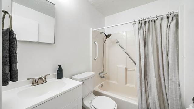 359 East 8400th Street South Sandy, UT 84070 - Photo 14 of 35 Full bathroom featuring shower / bath combo with shower curtain and vanity