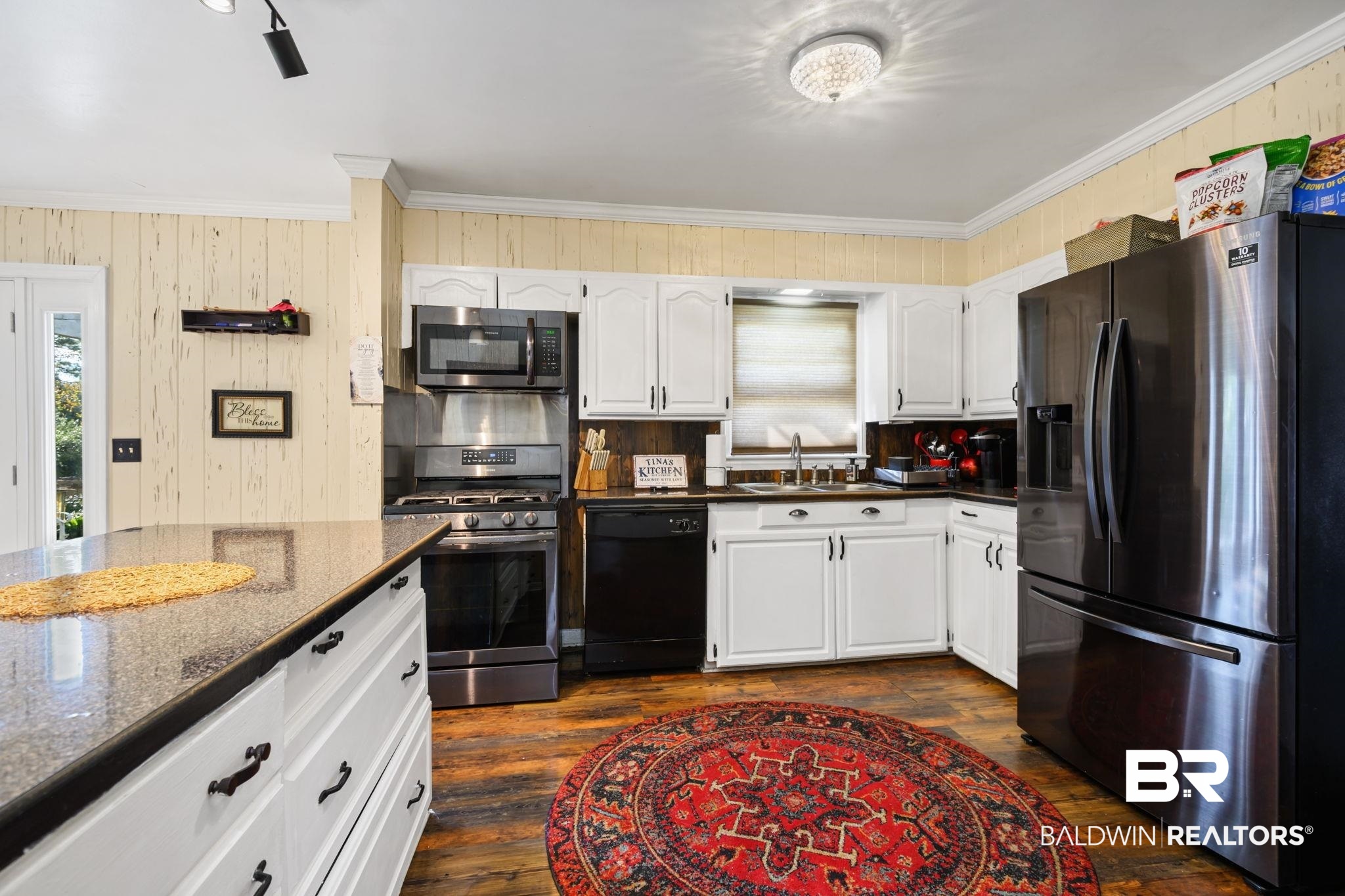 4105 Libby Drive Mobile, AL 36693 - Photo 9 of 26 Kitchen featuring sink, crown molding, appliances with stainless steel finishes, white cabinets, and dark stone counters