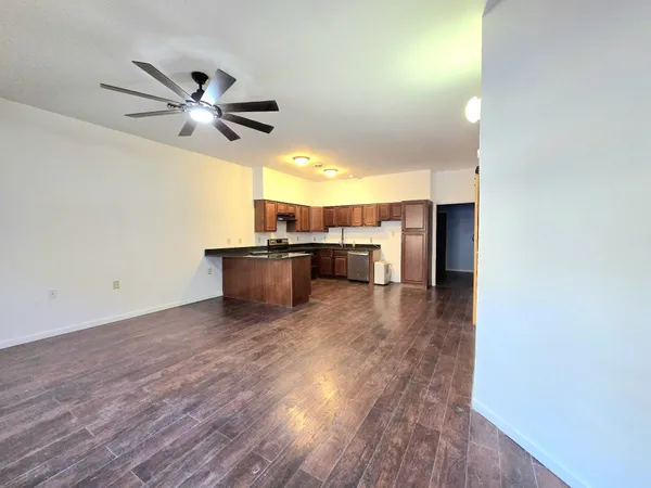 a view of a kitchen with a sink and a refrigerator