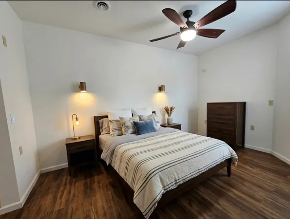 a bedroom with a bed and a lamp