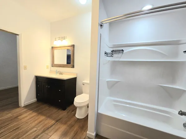 a bathroom with a sink vanity granite tub and shower