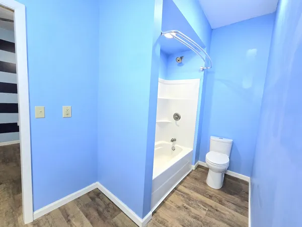 a bathroom with a toilet and a shower