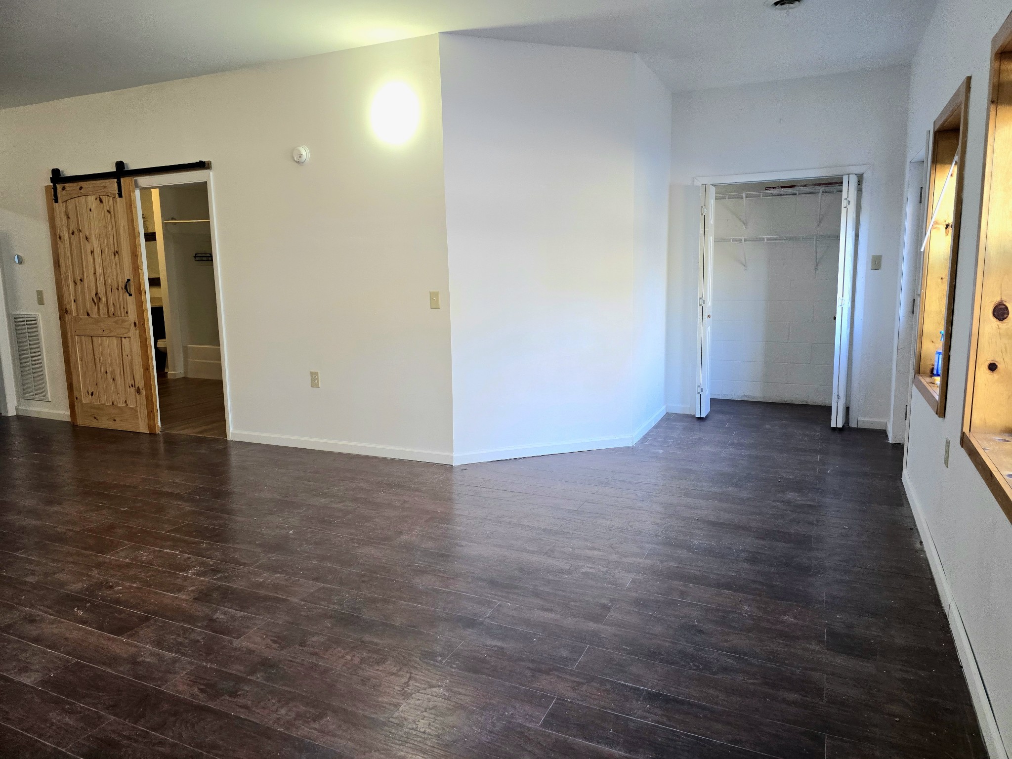 321 John Locke Road McMinnville, TN 37110 - Photo 6 of 57 a view of an empty room with wooden floor and a window