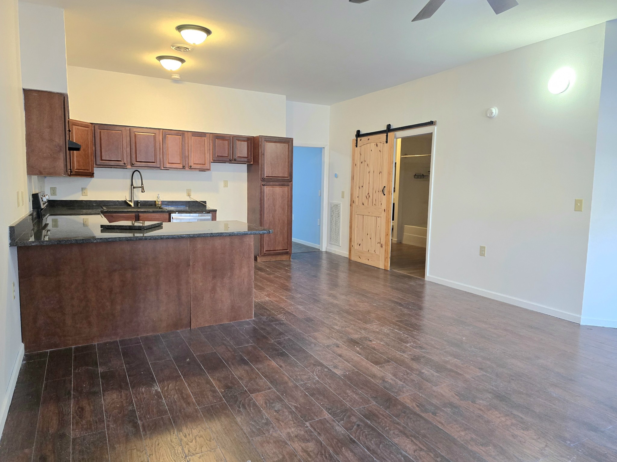 321 John Locke Road McMinnville, TN 37110 - Photo 7 of 57 a kitchen with stainless steel appliances granite countertop a stove a refrigerator a sink and dishwasher with wooden floor