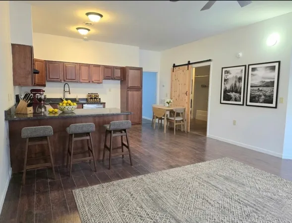 a dining room with furniture and wooden floor