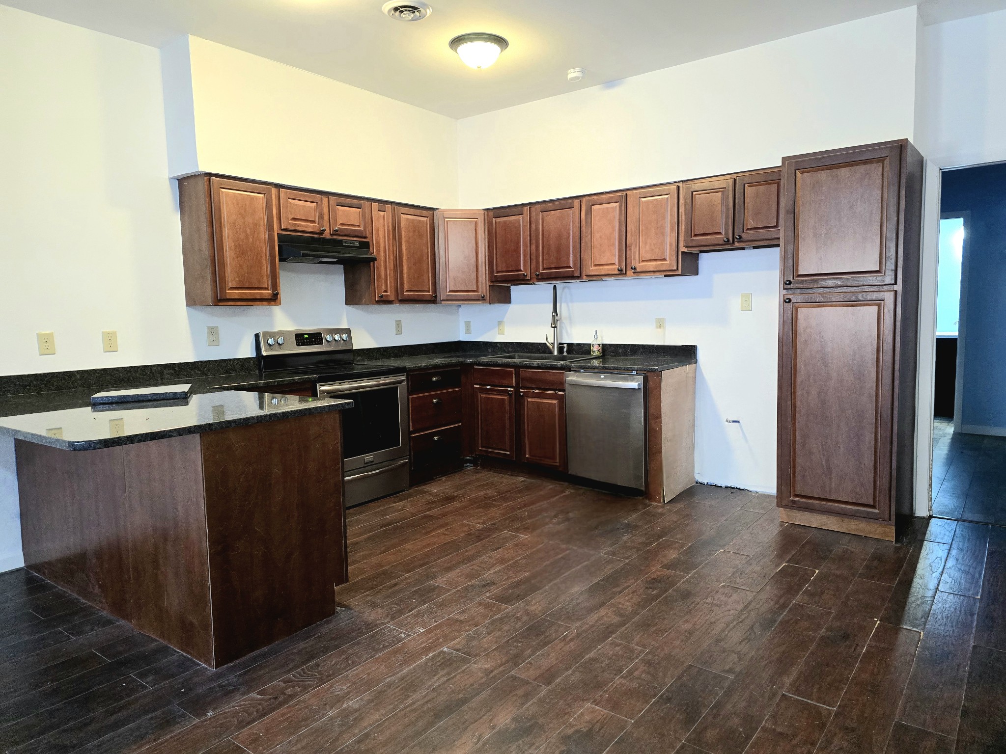 321 John Locke Road McMinnville, TN 37110 - Photo 9 of 57 a kitchen with stainless steel appliances granite countertop wooden cabinets a refrigerator and a stove