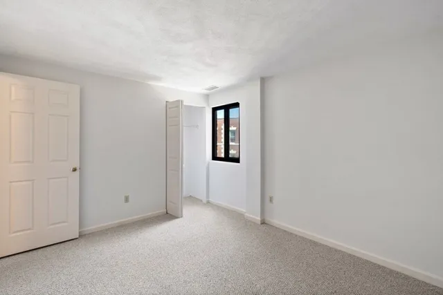 a view of an empty room and closet area