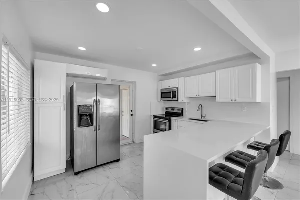 a kitchen with a sink stainless steel appliances and cabinets