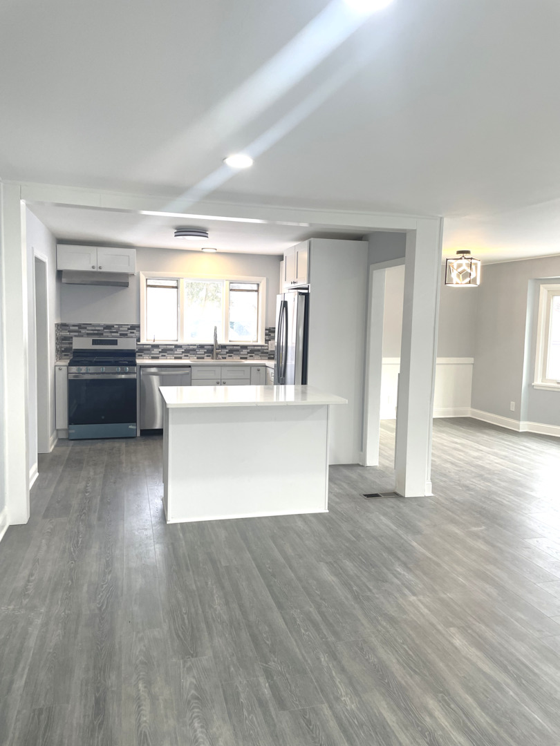205 Fairview Boulevard Rockford, IL 61107 - Photo 12 of 12 a large kitchen with a wooden floor and stainless steel appliances