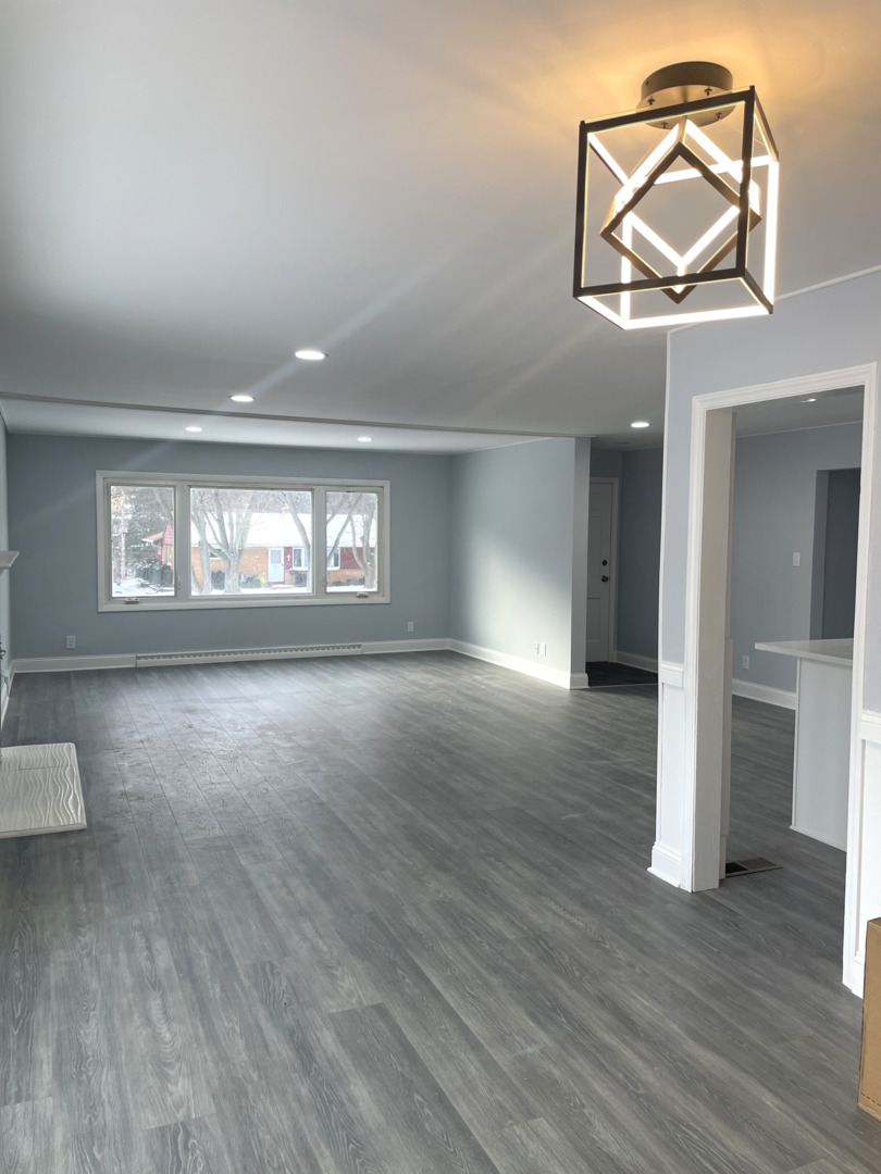 205 Fairview Boulevard Rockford, IL 61107 - Photo 4 of 12 wooden floor in an empty room with a window