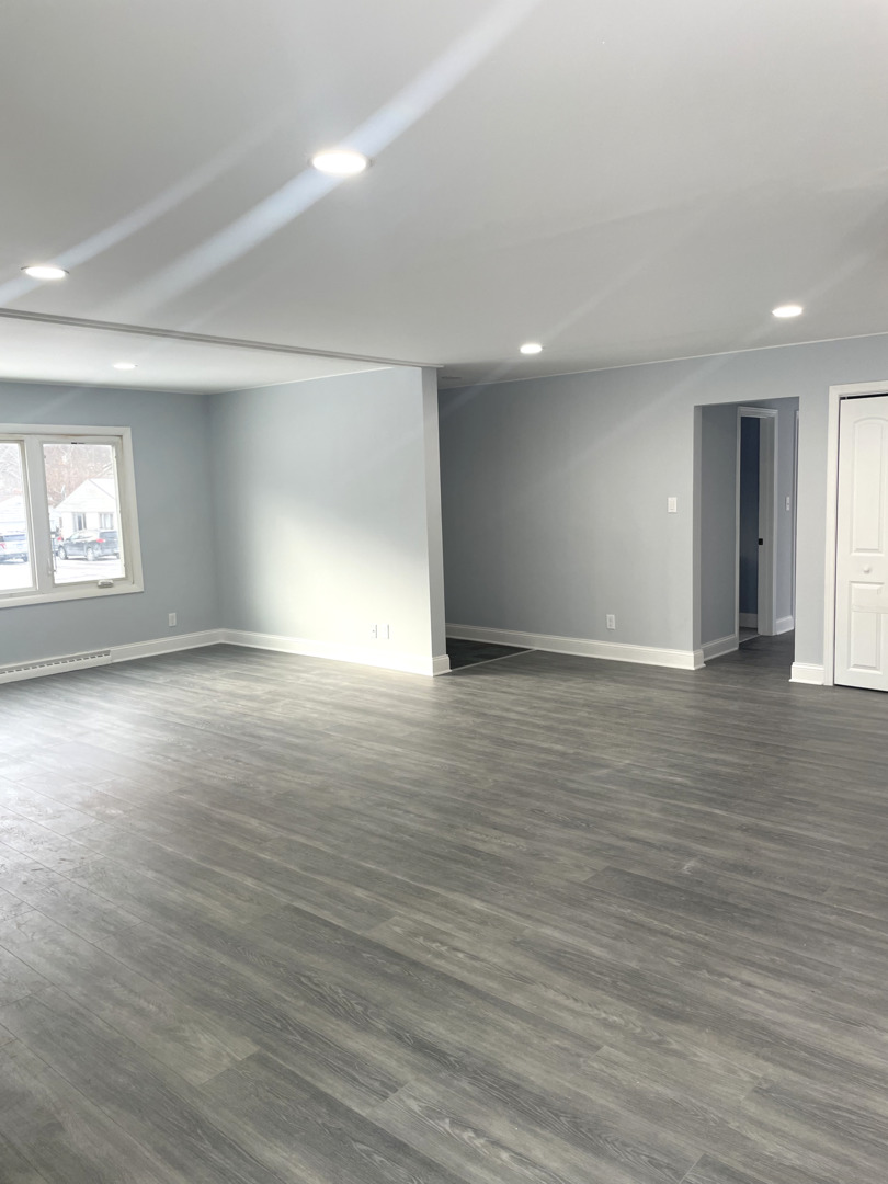 205 Fairview Boulevard Rockford, IL 61107 - Photo 5 of 12 an empty room with wooden floor and windows