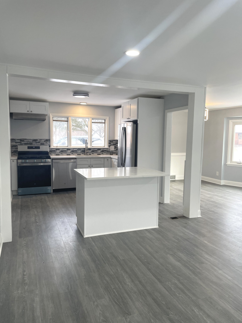 205 Fairview Boulevard Rockford, IL 61107 - Photo 8 of 12 a large kitchen with wooden floors and stainless steel appliances