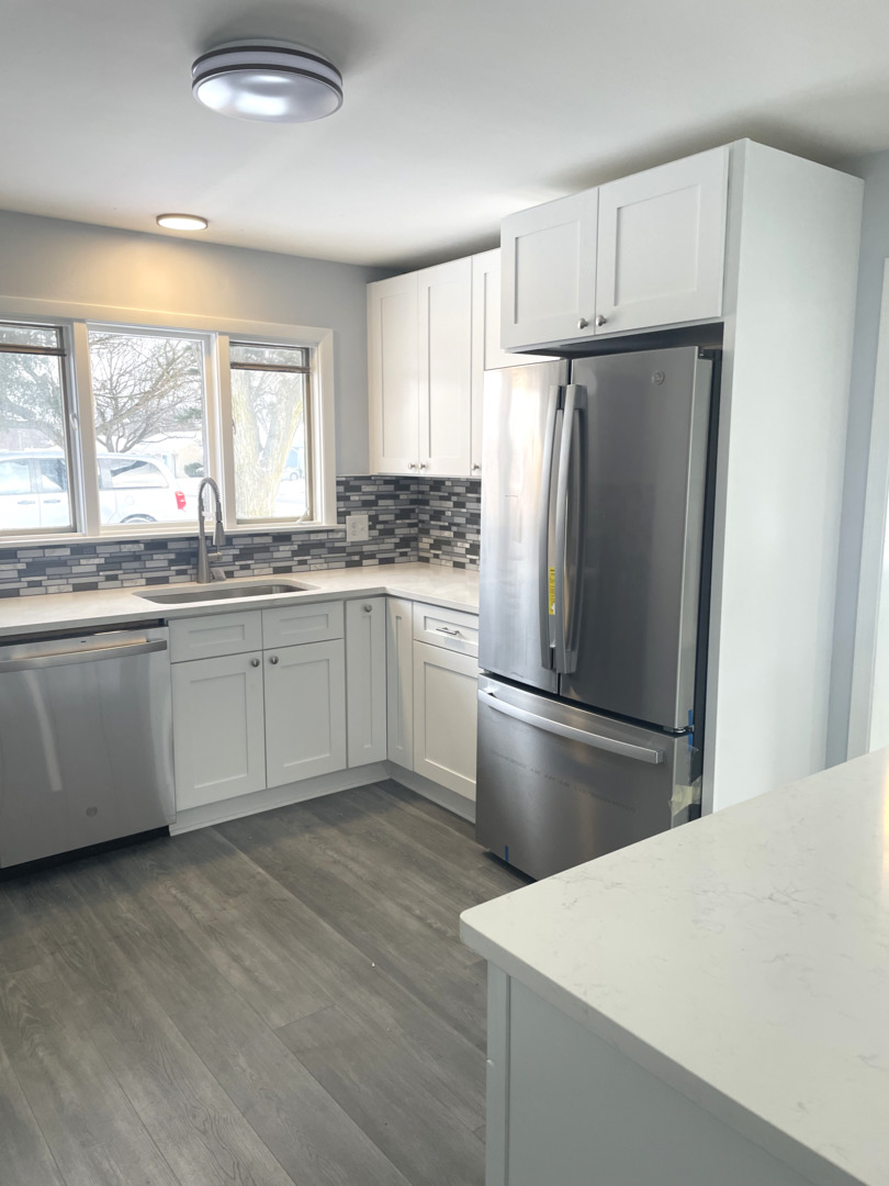 205 Fairview Boulevard Rockford, IL 61107 - Photo 9 of 12 a kitchen with stainless steel appliances granite countertop a refrigerator a sink a stove and white cabinets