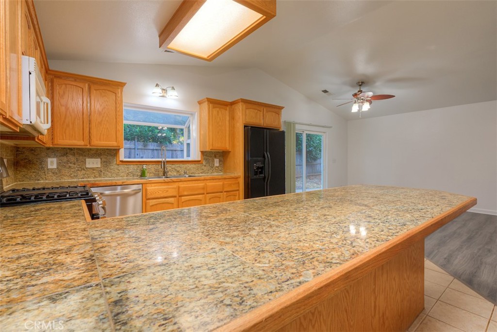 14503 Colter Way Magalia, CA 95954 - Photo 15 of 42 a bathroom with a granite countertop sink and a mirror