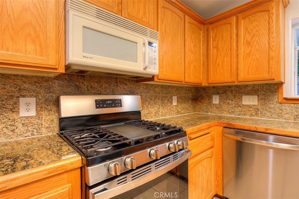 14503 Colter Way Magalia, CA 95954 - Photo 18 of 42 a kitchen with stainless steel appliances granite countertop a stove and a microwave