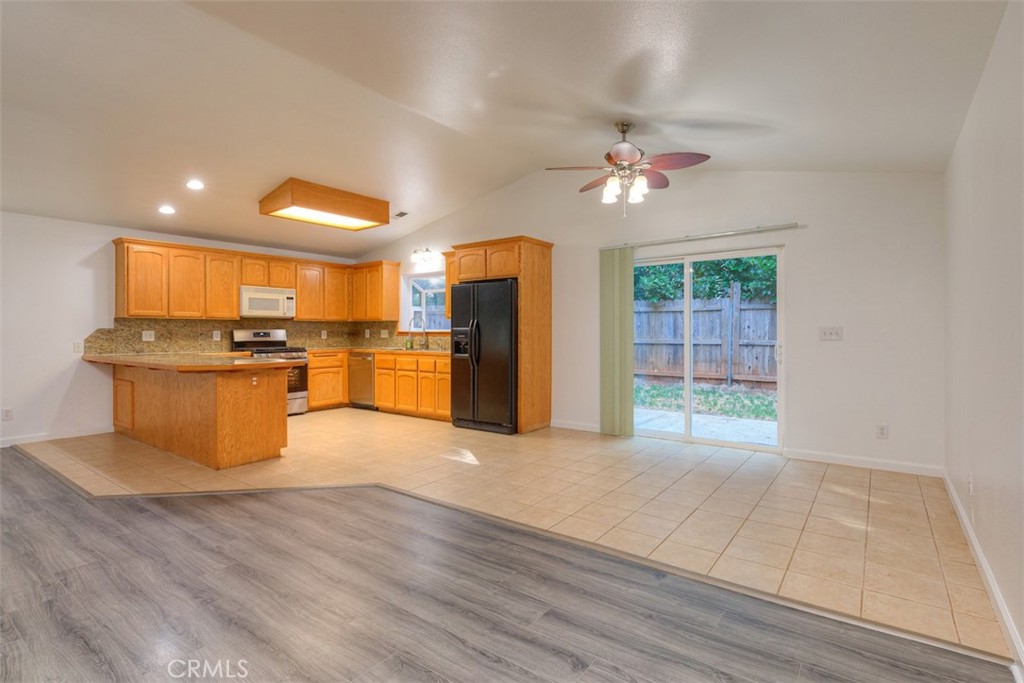 14503 Colter Way Magalia, CA 95954 - Photo 10 of 42 a view of a kitchen with wooden floor and a ceiling fan