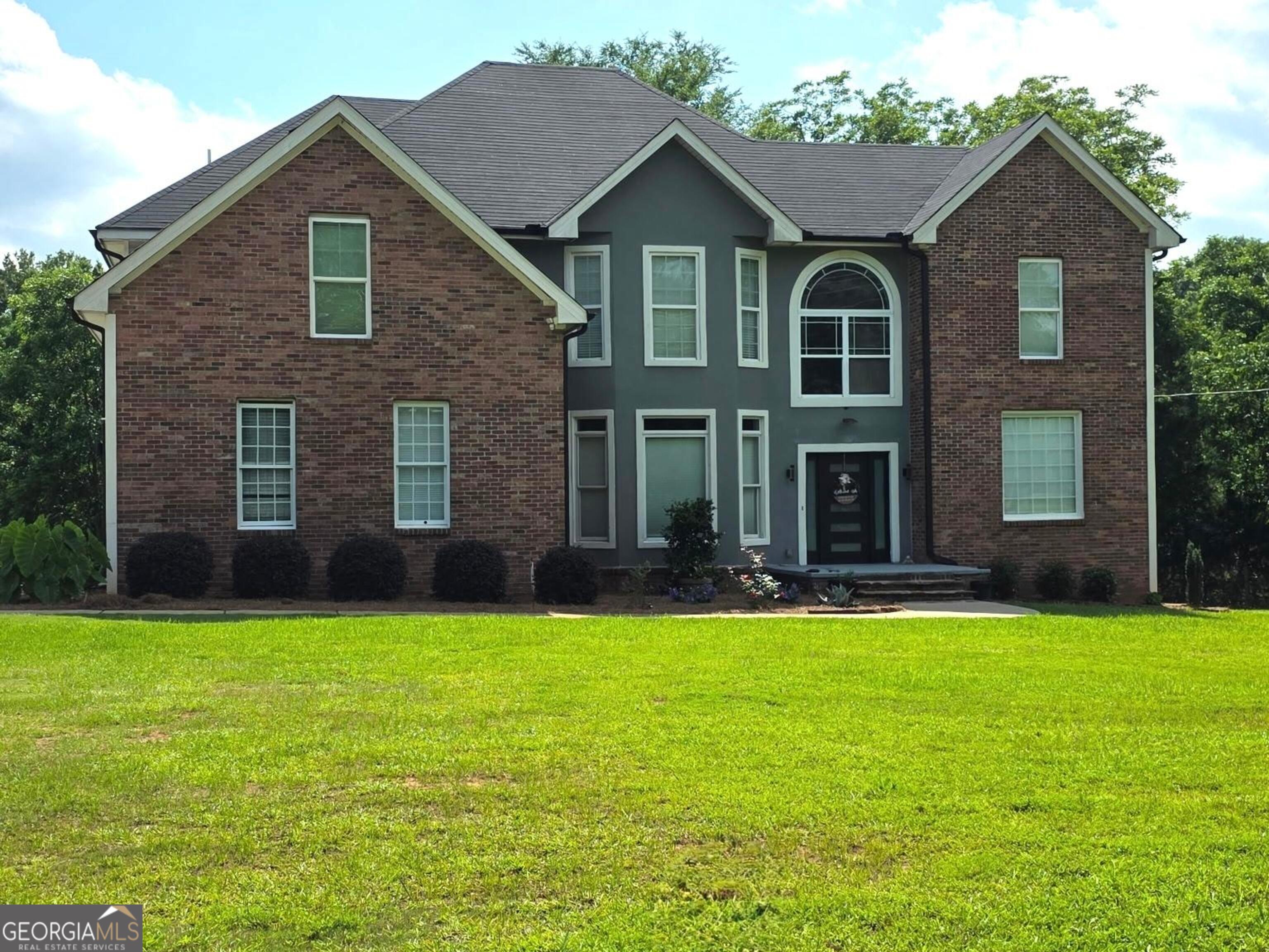 892 Perimeter Road Monticello, GA 31064 - Photo 1 of 38 a front view of a house with a yard