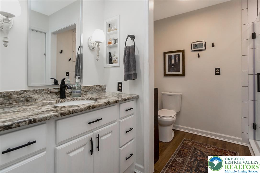 540 Briar Road Pen Argyl, PA 18072 - Photo 32 of 66 Granite counters and pristine white cabinetry elevate this well-appointed bathroom space.
