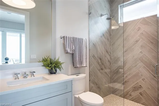 a bathroom with a sink toilet and shower