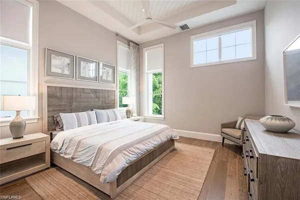 a bedroom with bed furniture and a large window