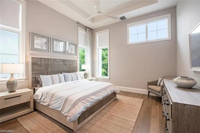 a bedroom with bed furniture and a large window