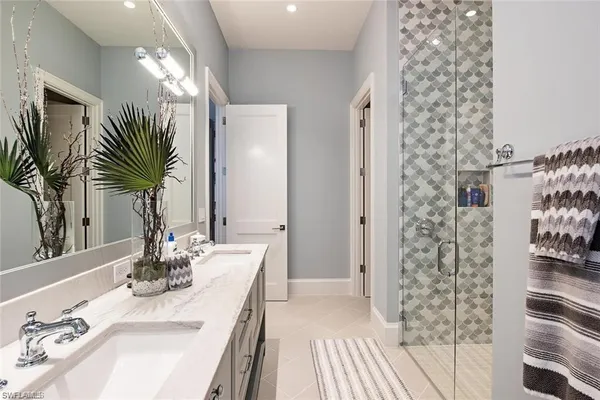 a bathroom with a sink double vanity and a mirror