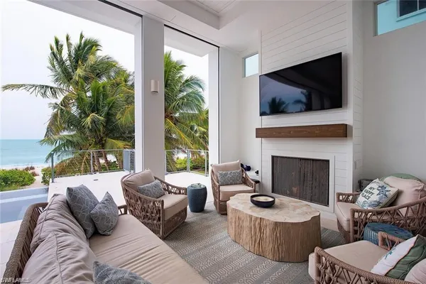 a living room with furniture fireplace and flat screen tv
