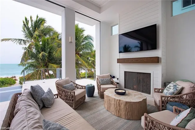 a living room with furniture fireplace and flat screen tv