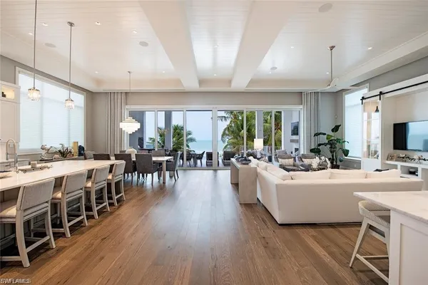 a large white kitchen with a large window