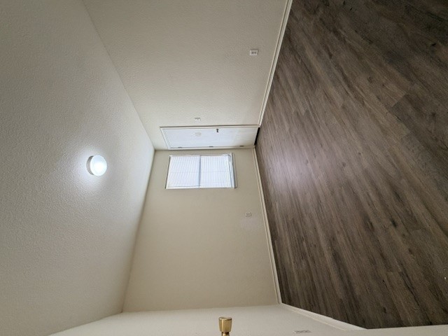 18421 Crestwind Lane Elgin, TX 78621 - Photo 30 of 34 Rich wood-inspired flooring pairs beautifully with neutral walls in this versatile room.