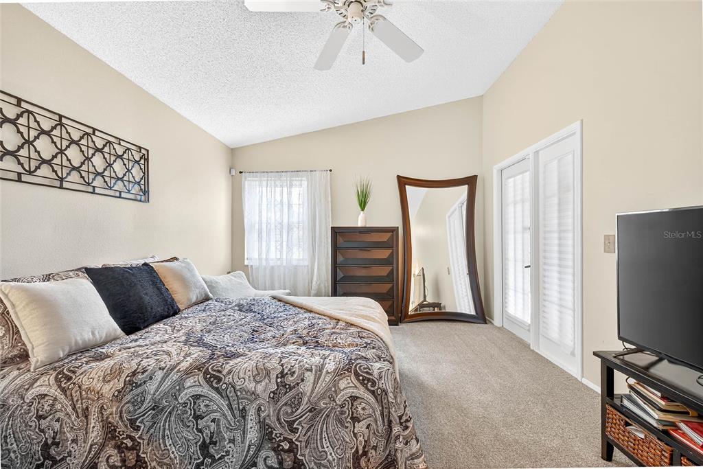 4658 Wallingford Court New Port Richey, FL 34655 - Photo 11 of 48 a bedroom with a bed and a flat tv screen on dresser