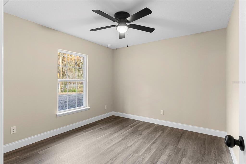 603 Moose Lodge Road, Unit A Bartow, FL 33830 - Photo 18 of 45 an empty room with a window and a ceiling fan