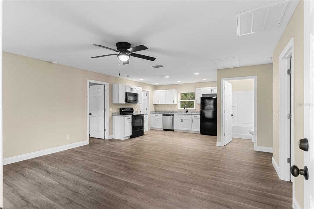 603 Moose Lodge Road, Unit A Bartow, FL 33830 - Photo 25 of 45 a large white kitchen with white cabinets stainless steel appliances