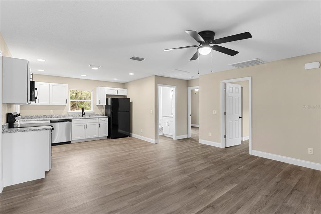 603 Moose Lodge Road, Unit A Bartow, FL 33830 - Photo 26 of 45 a view of a kitchen with wooden floor and stainless steel appliances
